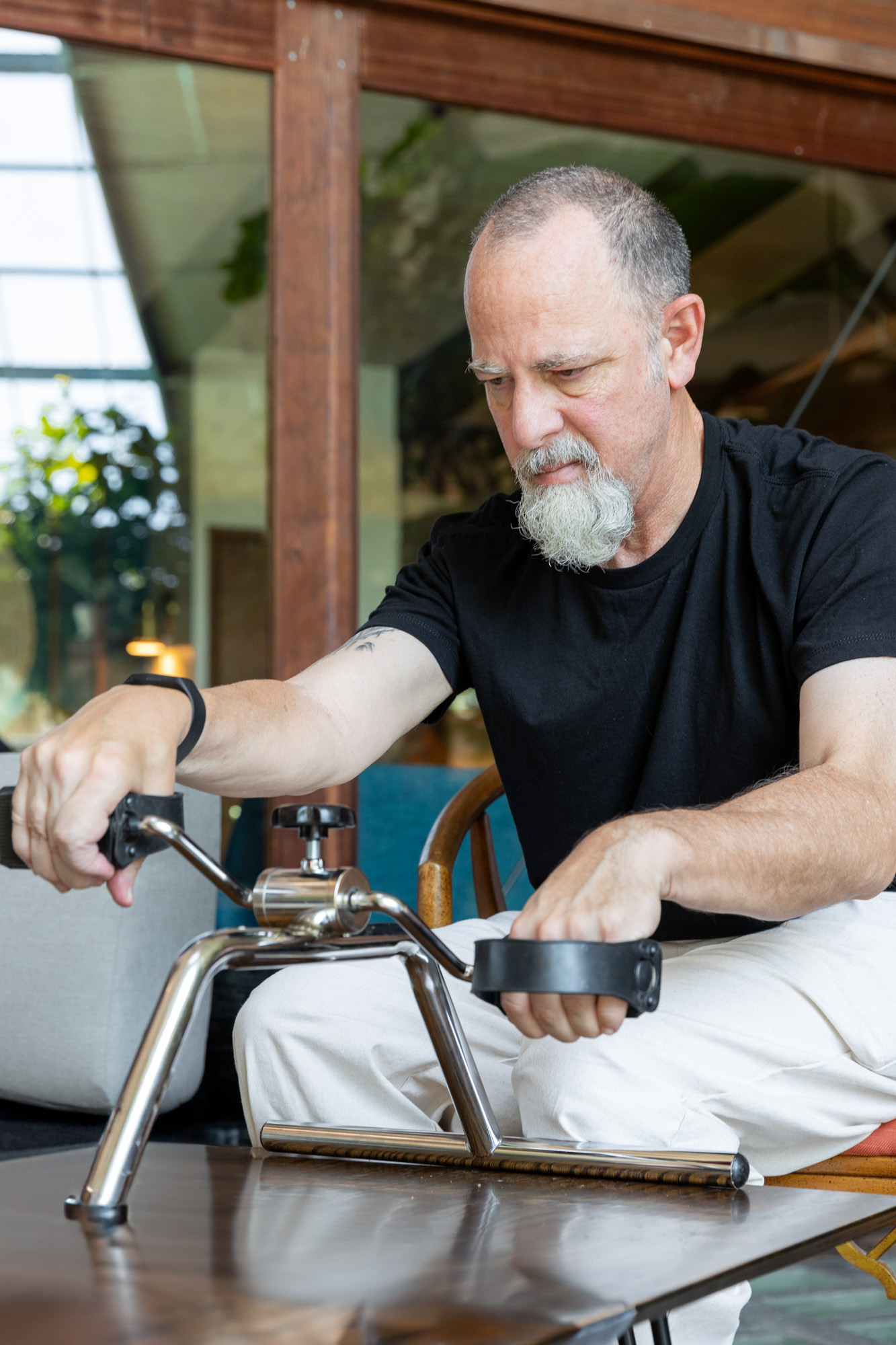 man uses a resistance machine shaped like a bike, to strengthen muscles and resistance